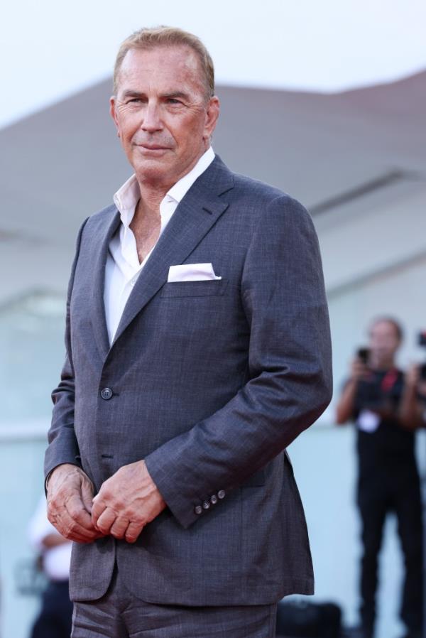 Kevin Costner smiling in a suit.