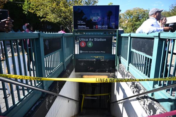 Utica subway station entrance with police tape on it