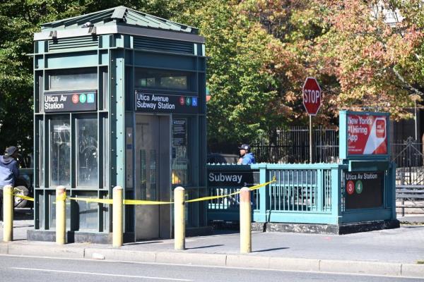 Utica subway station entrance with police tape on it