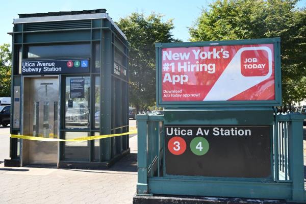 Utica subway station entrance with police tape on it